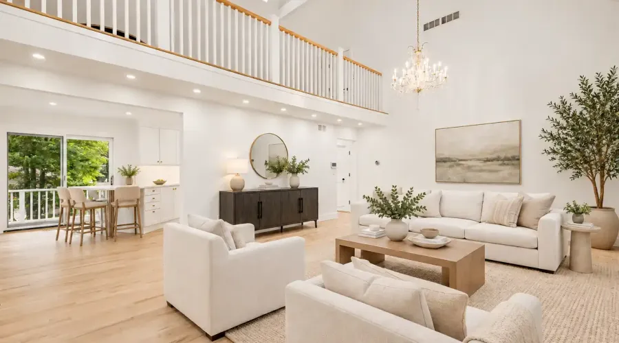Soaring ceilings and an expansive open layout create a dramatic sense of space, while walls of glass invite natural light and views of the surrounding greenery. Designed with an effortless flow between dining, living, and outdoor spaces, this is a home made for both relaxed everyday living and elegant entertaining.